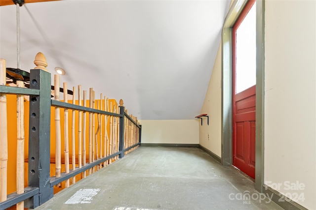 additional living space with baseboards and concrete flooring
