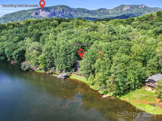 drone / aerial view featuring a water and mountain view