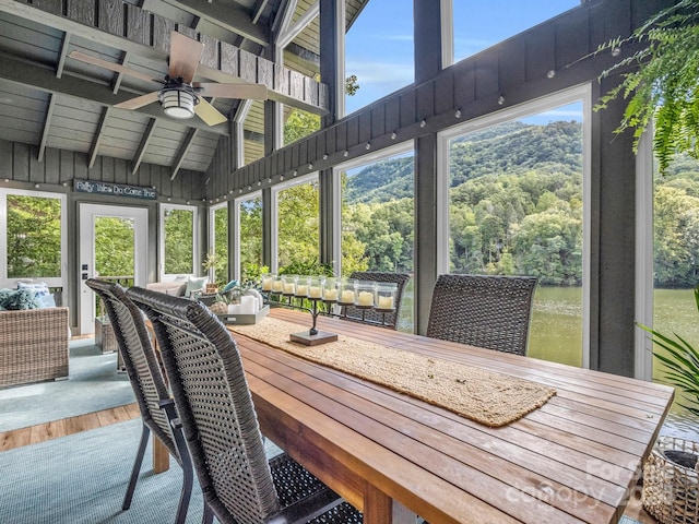 sunroom featuring ceiling fan and vaulted ceiling with beams