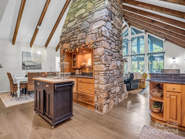 kitchen featuring a center island, beamed ceiling, high vaulted ceiling, and light hardwood / wood-style floors