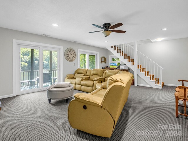 carpeted living room with ceiling fan