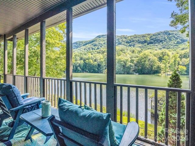 sunroom / solarium featuring a water view