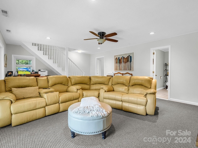 living room with ceiling fan and carpet