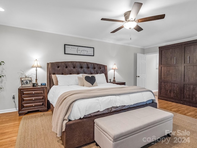 bedroom with ornamental molding, ceiling fan, and light hardwood / wood-style floors