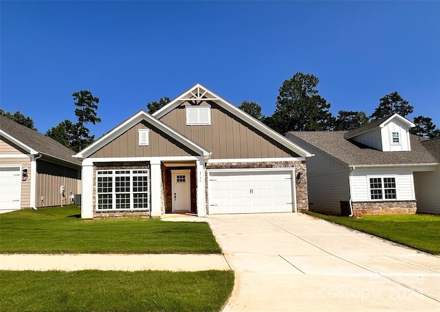 craftsman-style home featuring a garage and a front lawn