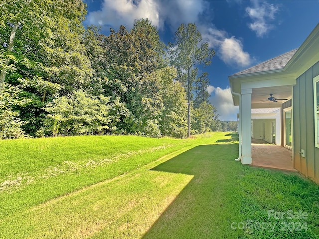 view of yard featuring ceiling fan and a patio area