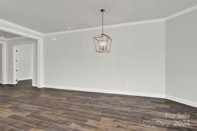 spare room with ornamental molding, an inviting chandelier, and dark hardwood / wood-style floors