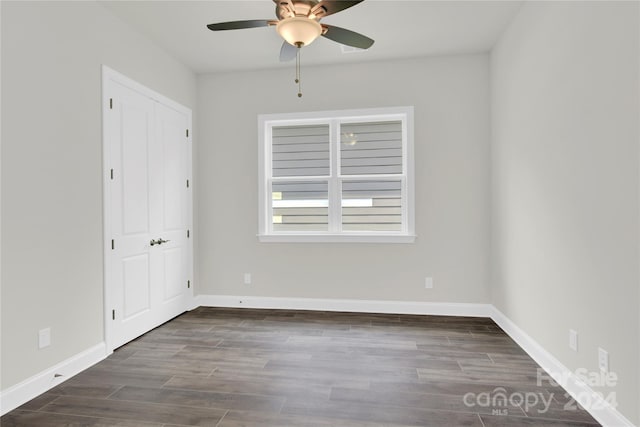 spare room with ceiling fan and dark hardwood / wood-style floors