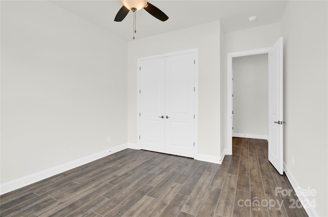 unfurnished bedroom featuring dark hardwood / wood-style flooring, a closet, and ceiling fan