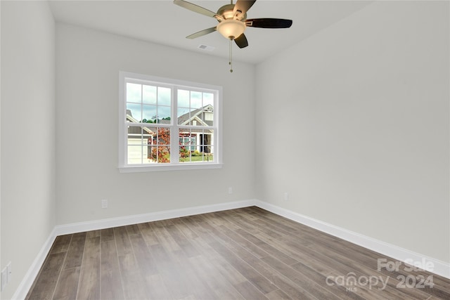 spare room featuring hardwood / wood-style floors and ceiling fan