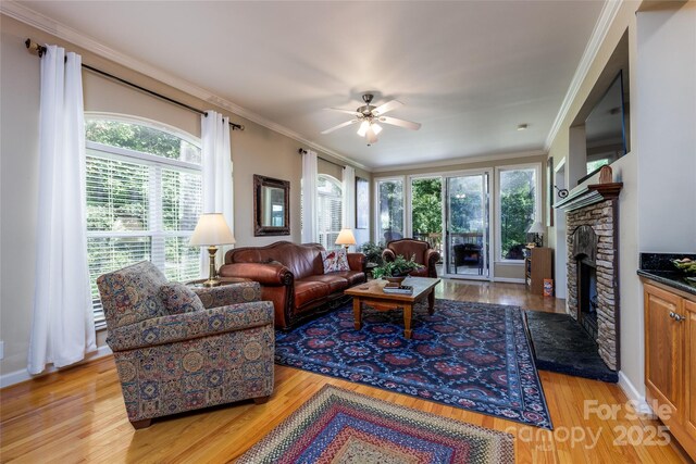 30 Lower Tanglewood Rd E Unit 1, Lake Toxaway, NC 28747 - living area featuring a ceiling fan, light wood-type flooring, ornamental molding, and a stone fireplace
