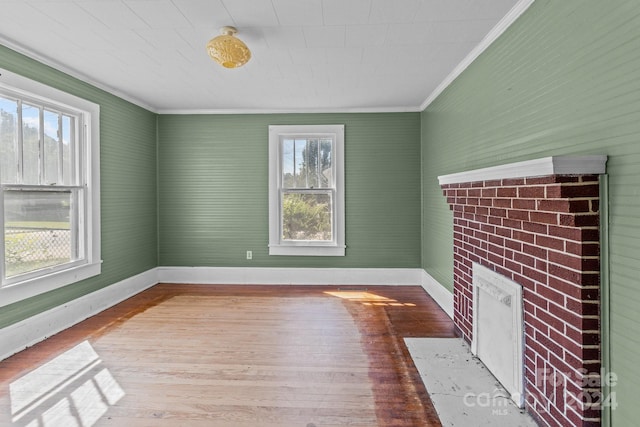 interior space with crown molding, wood-type flooring, and a healthy amount of sunlight