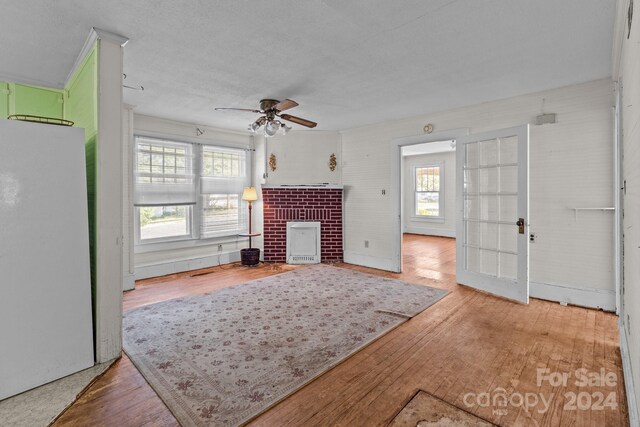 living room with ceiling fan, light hardwood / wood-style floors, and a wealth of natural light