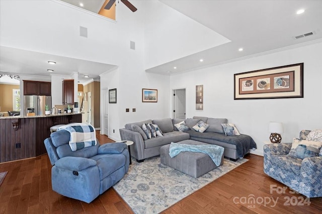 living room with crown molding, sink, ceiling fan, and dark hardwood / wood-style floors