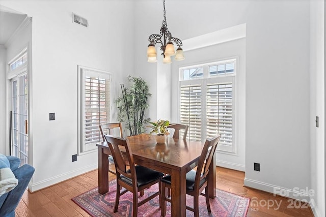 dining area featuring a chandelier and light hardwood / wood-style floors