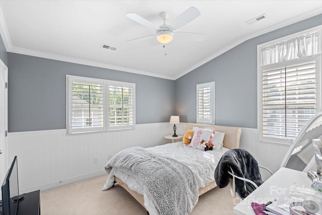 carpeted bedroom featuring crown molding, vaulted ceiling, and ceiling fan