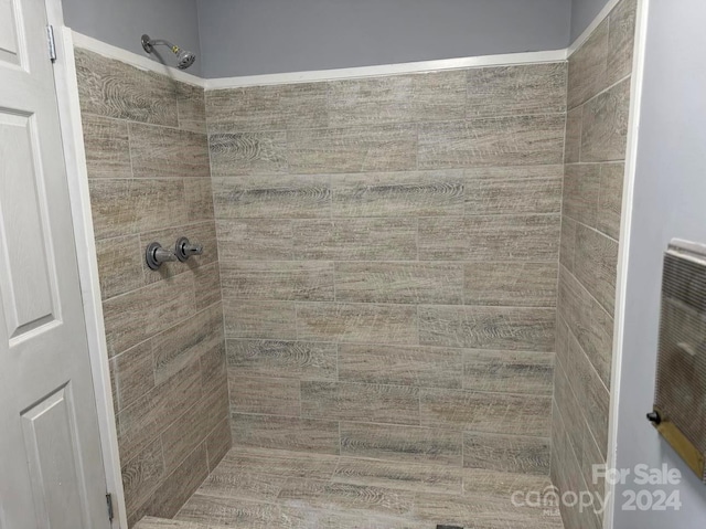 bathroom with tiled shower