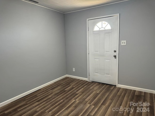 foyer featuring dark wood-style flooring and baseboards