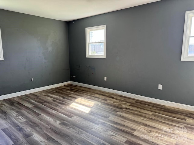 spare room with wood finished floors and baseboards