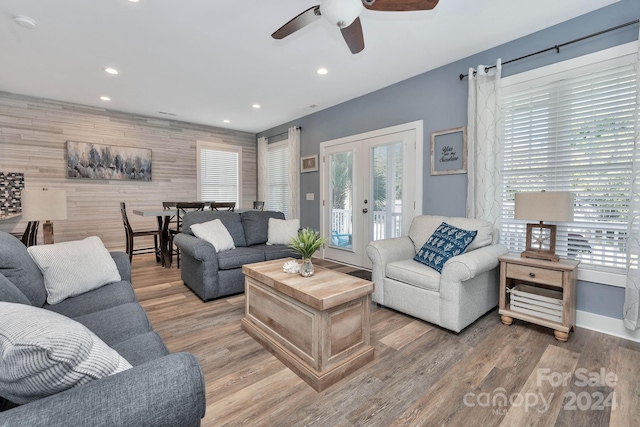 living room with hardwood / wood-style floors, french doors, and ceiling fan