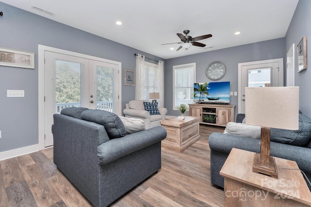 living room featuring french doors, wood-type flooring, and a wealth of natural light