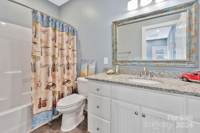 full bathroom featuring toilet, vanity, and shower / bath combination with curtain