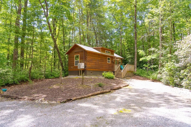 78 Smiling Fox Trl, Brevard, NC 28712 - view of home's exterior featuring a wooded view, cooling unit, and gravel driveway