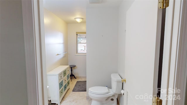 bathroom featuring tile patterned floors and toilet