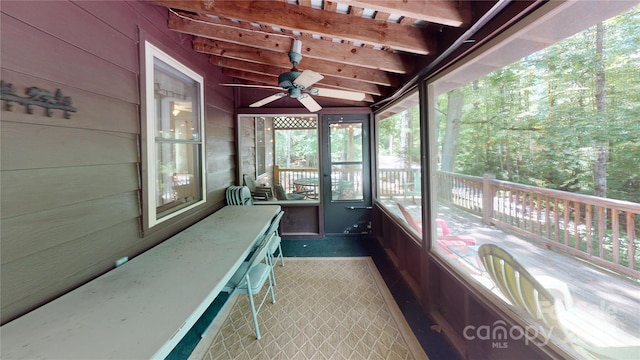 sunroom featuring ceiling fan and vaulted ceiling with beams