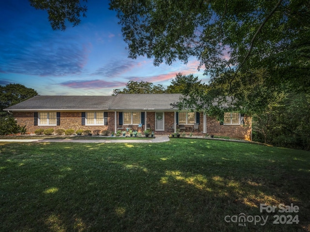 ranch-style house with a lawn