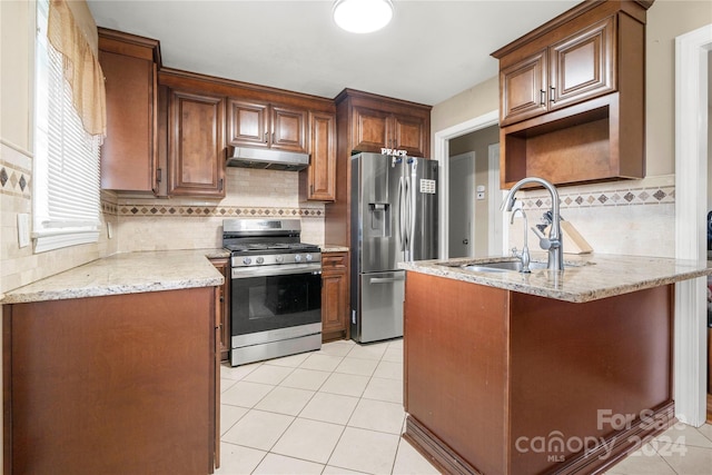 kitchen with backsplash, stainless steel appliances, sink, light stone countertops, and light tile patterned floors