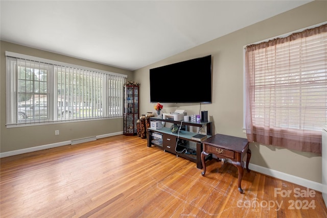 living room featuring light hardwood / wood-style floors and lofted ceiling