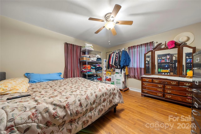 bedroom with ceiling fan and light wood-type flooring