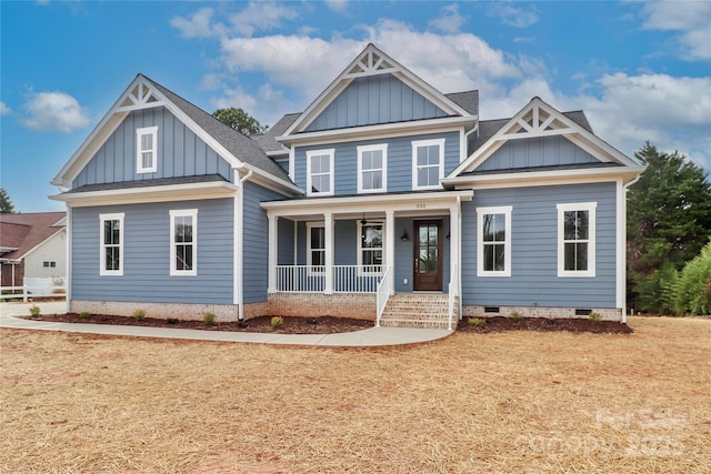 craftsman inspired home with a porch, crawl space, board and batten siding, and roof with shingles