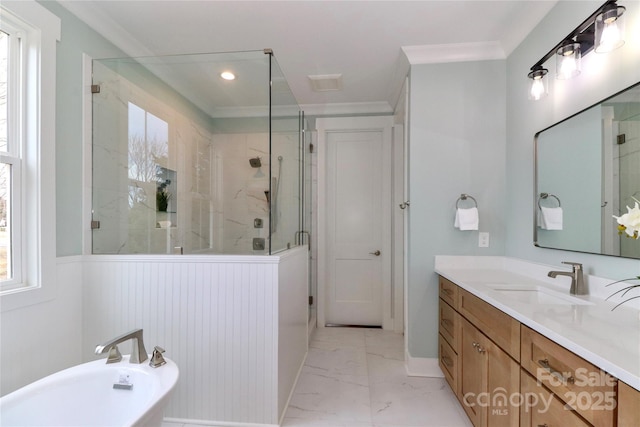 bathroom featuring a freestanding tub, marble finish floor, ornamental molding, a shower stall, and vanity