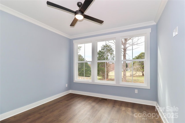 unfurnished room with dark wood-style floors, a healthy amount of sunlight, crown molding, and baseboards