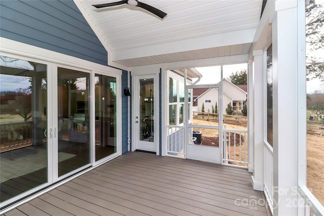 unfurnished sunroom featuring lofted ceiling and ceiling fan