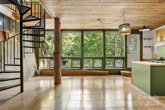 interior space featuring wood ceiling, light tile patterned floors, and a wealth of natural light