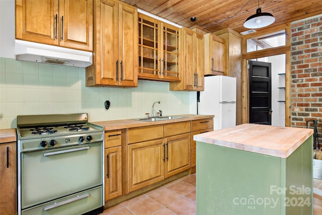 kitchen with sink, light tile patterned flooring, wooden ceiling, and white appliances