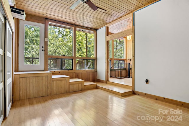 unfurnished sunroom with plenty of natural light and wooden ceiling