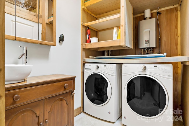 laundry area featuring separate washer and dryer, sink, cabinets, tankless water heater, and wood ceiling