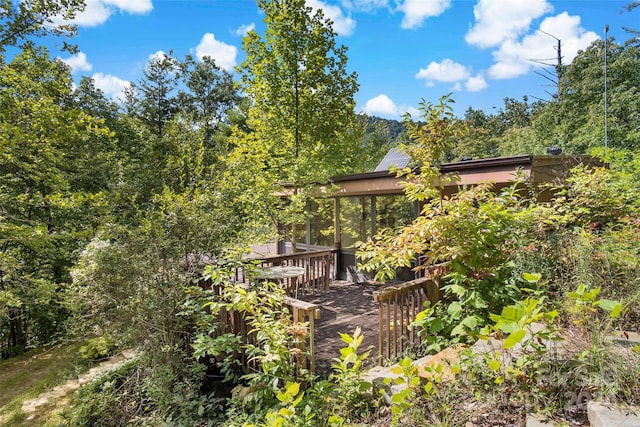 view of property exterior featuring a wooden deck