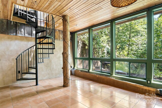 interior space featuring wood ceiling, plenty of natural light, and tile patterned flooring