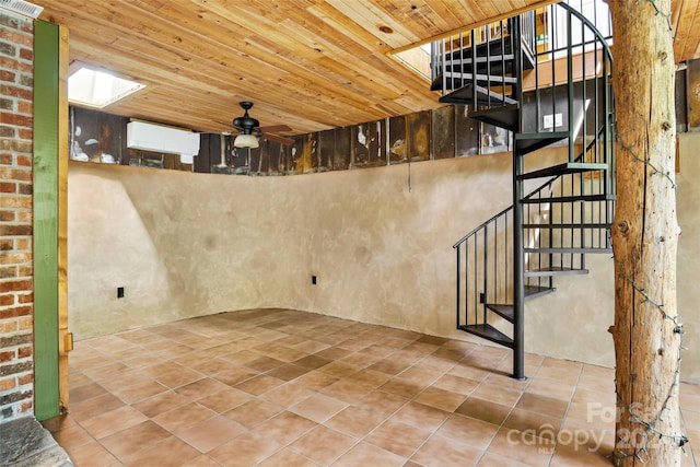 basement with tile patterned flooring, ceiling fan, and wooden ceiling