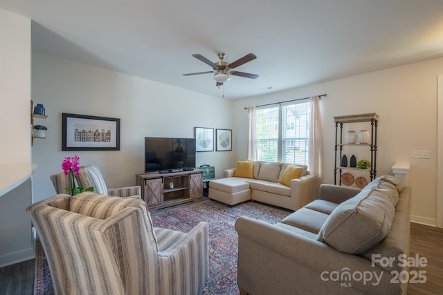 living room featuring ceiling fan and dark hardwood / wood-style flooring