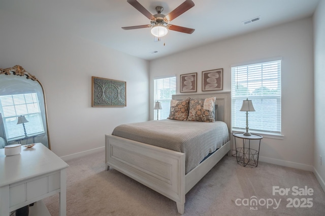 bedroom featuring light colored carpet and ceiling fan