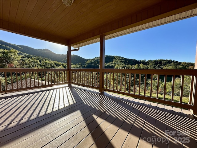 wooden deck with a mountain view