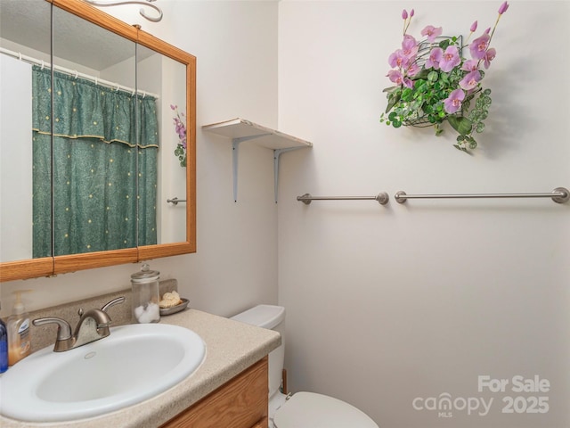 bathroom featuring vanity and toilet