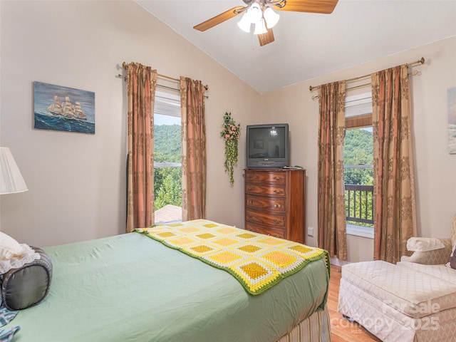 bedroom featuring multiple windows, ceiling fan, and vaulted ceiling