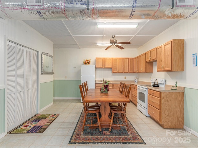 dining room with light tile patterned floors and ceiling fan